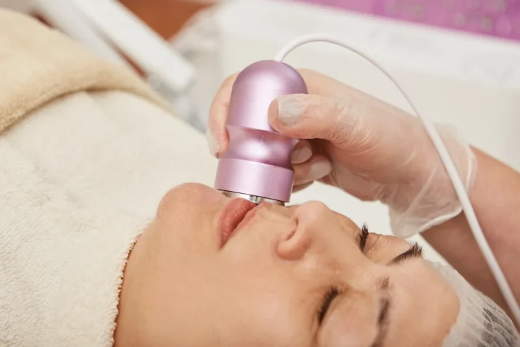 middle-aged-woman-receiving-facial-treatment-in-cl-2023-11-27-05-07-31-utc